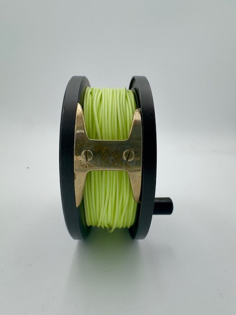 Orvis CFO V fishing reel with vibrant green line on a sleek black spool, ideal for anglers of all levels.