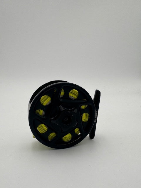 Compact Ross Airus 1 fishing reel with sleek black design and vibrant yellow accents, perfect for anglers.