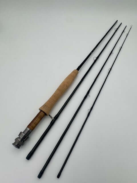 G.Loomis Asquith fly fishing rod with cork handle and black guides, showcasing fine craftsmanship and sensitivity.