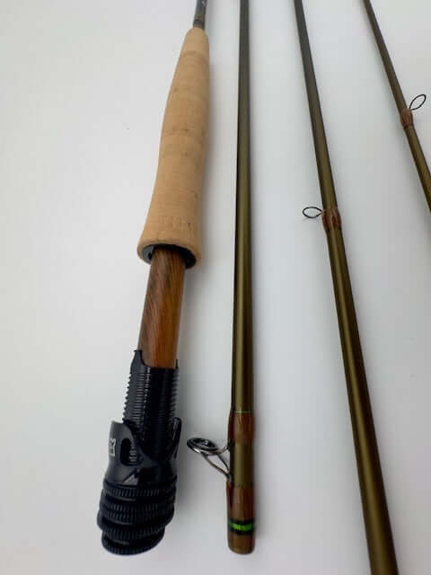 Hardy Marksman 10' 4wt fishing rod showing cork handle and olive green sections, designed for precision and durability.