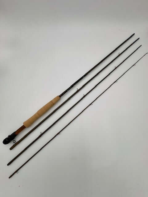 Hardy Marksman 10' 4wt fishing rod in olive green, featuring three sections and a comfortable grip for anglers.