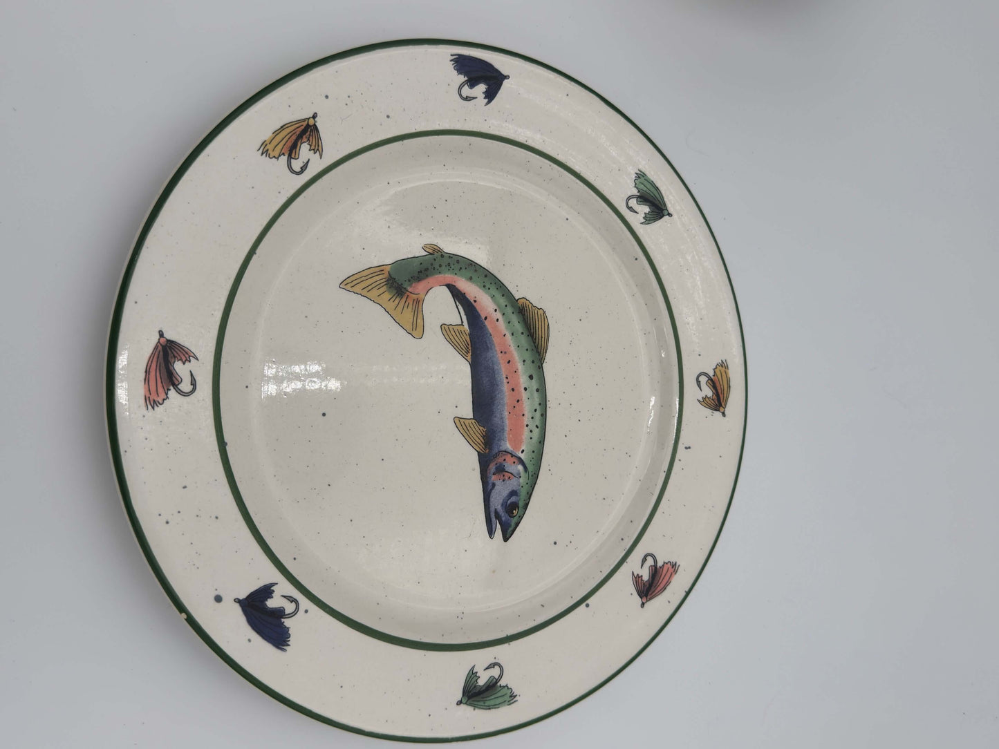 Vintage trout plate from Lenox Fishing Plate set, featuring colorful fly designs, perfect for rustic table settings.