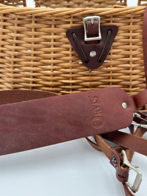 Orvis wicker basket with leather strap, perfect for fishing tackle and outdoor adventures.