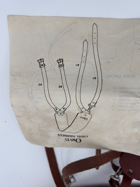 Instruction manual illustration for Orvis Catt Harness, showing straps and measuring guidelines.