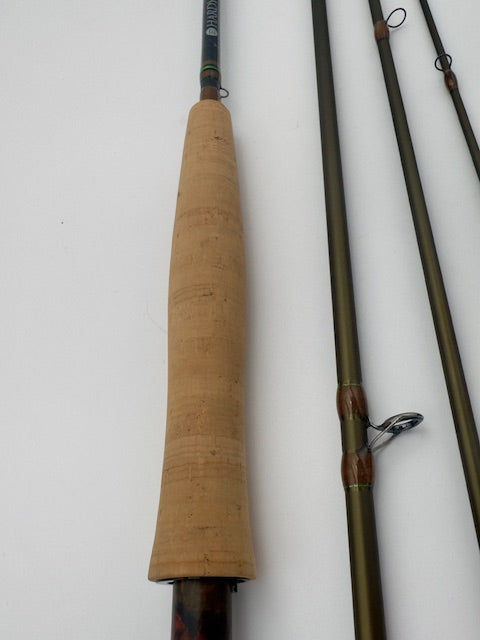 Close-up of the Hardy Marksman 8'6" 4wt fishing rod handle, showcasing its cork grip and rod sections.